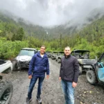 Cruising with Danny and Peter, Holland America Line, Westerdam, Ketchikan, Alaska, United States, Adventure History Thrills | A vibrant collage capturing the Ketchikan Adventure Tour in Alaska, featuring a dynamic log-rolling contest at the Great Alaskan Lumberjack Show with lumberjacks in plaid shirts balancing on a floating log, a rugged UTV navigating a muddy trail through the Tongass National Forest with George Inlet Fjords’ turquoise waters in view, a serene scenic cruise along the Inside Passage with a bald eagle soaring above mist-covered mountains, and a cozy scene at George Inlet Lodge with a rustic table set with craft beers, creamy crab chowder, hot Dungeness crab, and blueberry cheesecake. In the background, Ketchikan’s historic Creek Street showcases colorful buildings on stilts and a Tlingit totem pole, framed by lush greenery and rugged Alaskan peaks, embodying the city’s thrilling adventures and rich cultural heritage.