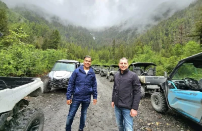 Cruising with Danny and Peter, Holland America Line, Westerdam, Ketchikan, Alaska, United States, Adventure History Thrills | A vibrant collage capturing the Ketchikan Adventure Tour in Alaska, featuring a dynamic log-rolling contest at the Great Alaskan Lumberjack Show with lumberjacks in plaid shirts balancing on a floating log, a rugged UTV navigating a muddy trail through the Tongass National Forest with George Inlet Fjords’ turquoise waters in view, a serene scenic cruise along the Inside Passage with a bald eagle soaring above mist-covered mountains, and a cozy scene at George Inlet Lodge with a rustic table set with craft beers, creamy crab chowder, hot Dungeness crab, and blueberry cheesecake. In the background, Ketchikan’s historic Creek Street showcases colorful buildings on stilts and a Tlingit totem pole, framed by lush greenery and rugged Alaskan peaks, embodying the city’s thrilling adventures and rich cultural heritage.