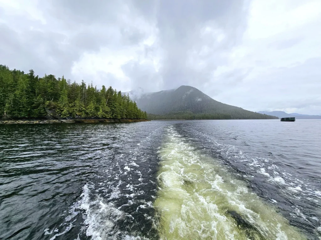 Cruising with Danny and Peter, Holland America Line, Westerdam, Ketchikan, Alaska, United States, Adventure History Thrills | A vibrant collage capturing the Ketchikan Adventure Tour in Alaska, featuring a dynamic log-rolling contest at the Great Alaskan Lumberjack Show with lumberjacks in plaid shirts balancing on a floating log, a rugged UTV navigating a muddy trail through the Tongass National Forest with George Inlet Fjords’ turquoise waters in view, a serene scenic cruise along the Inside Passage with a bald eagle soaring above mist-covered mountains, and a cozy scene at George Inlet Lodge with a rustic table set with craft beers, creamy crab chowder, hot Dungeness crab, and blueberry cheesecake. In the background, Ketchikan’s historic Creek Street showcases colorful buildings on stilts and a Tlingit totem pole, framed by lush greenery and rugged Alaskan peaks, embodying the city’s thrilling adventures and rich cultural heritage.