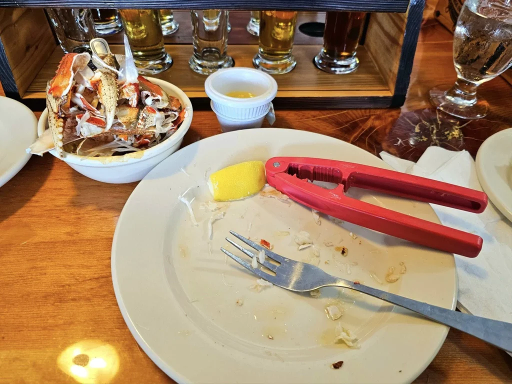 Cruising with Danny and Peter, Holland America Line, Westerdam, Ketchikan, Alaska, United States, Adventure History Thrills | A vibrant collage capturing the Ketchikan Adventure Tour in Alaska, featuring a dynamic log-rolling contest at the Great Alaskan Lumberjack Show with lumberjacks in plaid shirts balancing on a floating log, a rugged UTV navigating a muddy trail through the Tongass National Forest with George Inlet Fjords’ turquoise waters in view, a serene scenic cruise along the Inside Passage with a bald eagle soaring above mist-covered mountains, and a cozy scene at George Inlet Lodge with a rustic table set with craft beers, creamy crab chowder, hot Dungeness crab, and blueberry cheesecake. In the background, Ketchikan’s historic Creek Street showcases colorful buildings on stilts and a Tlingit totem pole, framed by lush greenery and rugged Alaskan peaks, embodying the city’s thrilling adventures and rich cultural heritage.