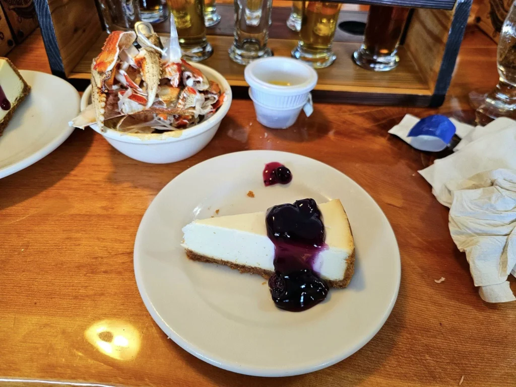 Cruising with Danny and Peter, Holland America Line, Westerdam, Ketchikan, Alaska, United States, Adventure History Thrills | A vibrant collage capturing the Ketchikan Adventure Tour in Alaska, featuring a dynamic log-rolling contest at the Great Alaskan Lumberjack Show with lumberjacks in plaid shirts balancing on a floating log, a rugged UTV navigating a muddy trail through the Tongass National Forest with George Inlet Fjords’ turquoise waters in view, a serene scenic cruise along the Inside Passage with a bald eagle soaring above mist-covered mountains, and a cozy scene at George Inlet Lodge with a rustic table set with craft beers, creamy crab chowder, hot Dungeness crab, and blueberry cheesecake. In the background, Ketchikan’s historic Creek Street showcases colorful buildings on stilts and a Tlingit totem pole, framed by lush greenery and rugged Alaskan peaks, embodying the city’s thrilling adventures and rich cultural heritage.