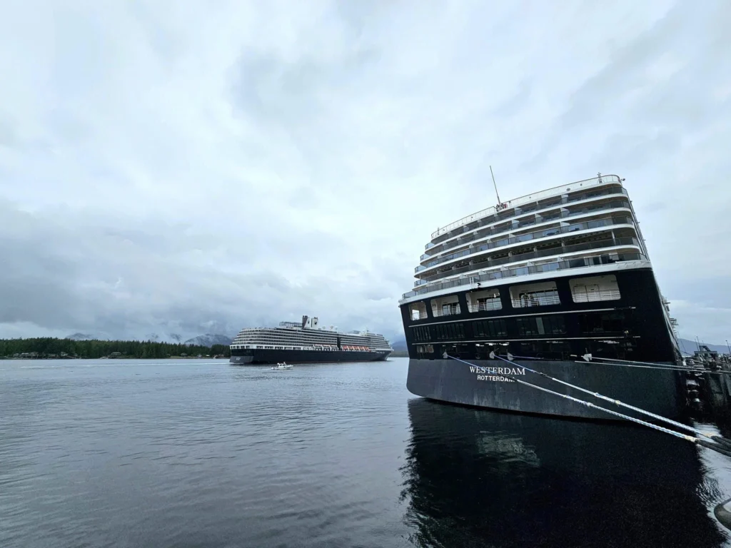 Cruising with Danny and Peter, Holland America Line, Westerdam, Ketchikan, Alaska, United States, Adventure History Thrills | A vibrant collage capturing the Ketchikan Adventure Tour in Alaska, featuring a dynamic log-rolling contest at the Great Alaskan Lumberjack Show with lumberjacks in plaid shirts balancing on a floating log, a rugged UTV navigating a muddy trail through the Tongass National Forest with George Inlet Fjords’ turquoise waters in view, a serene scenic cruise along the Inside Passage with a bald eagle soaring above mist-covered mountains, and a cozy scene at George Inlet Lodge with a rustic table set with craft beers, creamy crab chowder, hot Dungeness crab, and blueberry cheesecake. In the background, Ketchikan’s historic Creek Street showcases colorful buildings on stilts and a Tlingit totem pole, framed by lush greenery and rugged Alaskan peaks, embodying the city’s thrilling adventures and rich cultural heritage.