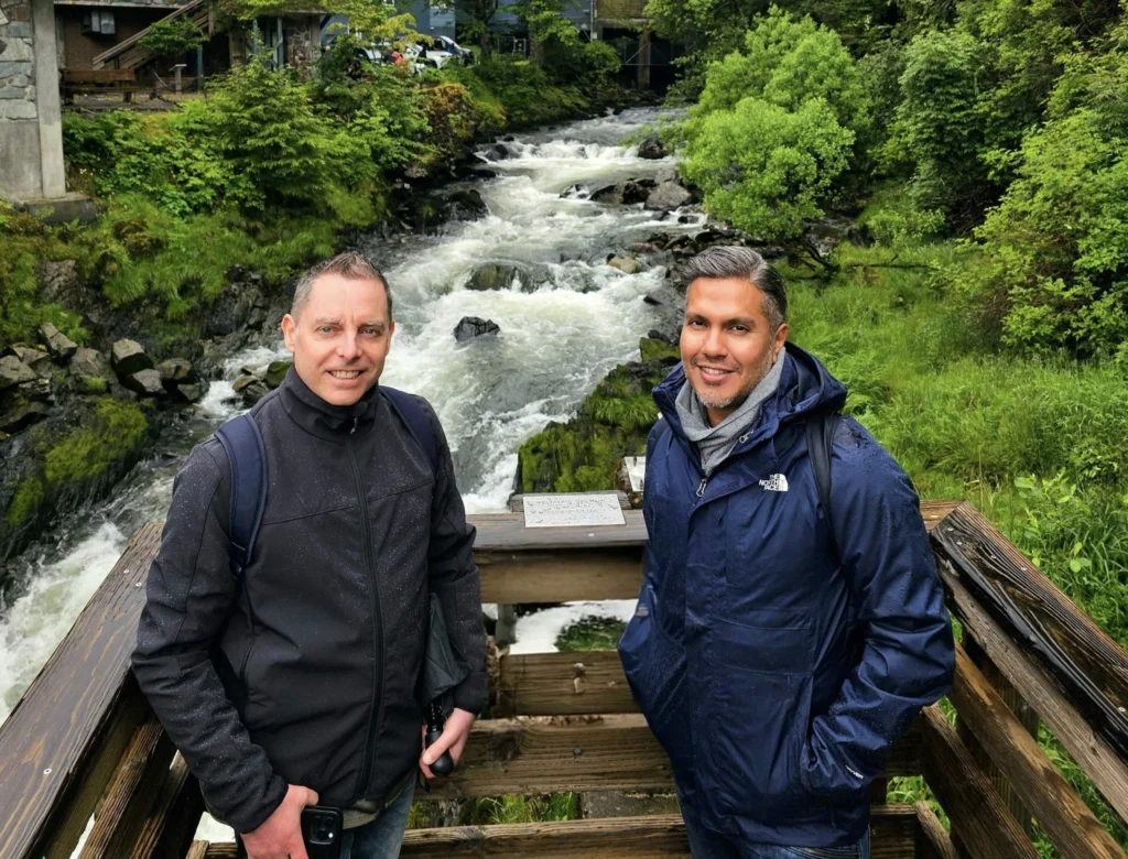 Cruising with Danny and Peter, Holland America Line, Westerdam, Ketchikan, Alaska, United States, Adventure History Thrills | A vibrant collage capturing the Ketchikan Adventure Tour in Alaska, featuring a dynamic log-rolling contest at the Great Alaskan Lumberjack Show with lumberjacks in plaid shirts balancing on a floating log, a rugged UTV navigating a muddy trail through the Tongass National Forest with George Inlet Fjords’ turquoise waters in view, a serene scenic cruise along the Inside Passage with a bald eagle soaring above mist-covered mountains, and a cozy scene at George Inlet Lodge with a rustic table set with craft beers, creamy crab chowder, hot Dungeness crab, and blueberry cheesecake. In the background, Ketchikan’s historic Creek Street showcases colorful buildings on stilts and a Tlingit totem pole, framed by lush greenery and rugged Alaskan peaks, embodying the city’s thrilling adventures and rich cultural heritage.