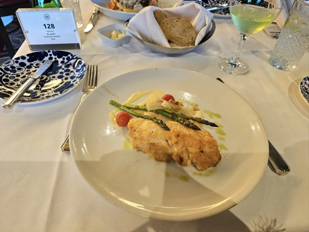 Cruising with Danny and Peter, Holland America Line, Westerdam, Ketchikan, Alaska, United States, Adventure History Thrills | A vibrant collage capturing the Ketchikan Adventure Tour in Alaska, featuring a dynamic log-rolling contest at the Great Alaskan Lumberjack Show with lumberjacks in plaid shirts balancing on a floating log, a rugged UTV navigating a muddy trail through the Tongass National Forest with George Inlet Fjords’ turquoise waters in view, a serene scenic cruise along the Inside Passage with a bald eagle soaring above mist-covered mountains, and a cozy scene at George Inlet Lodge with a rustic table set with craft beers, creamy crab chowder, hot Dungeness crab, and blueberry cheesecake. In the background, Ketchikan’s historic Creek Street showcases colorful buildings on stilts and a Tlingit totem pole, framed by lush greenery and rugged Alaskan peaks, embodying the city’s thrilling adventures and rich cultural heritage.