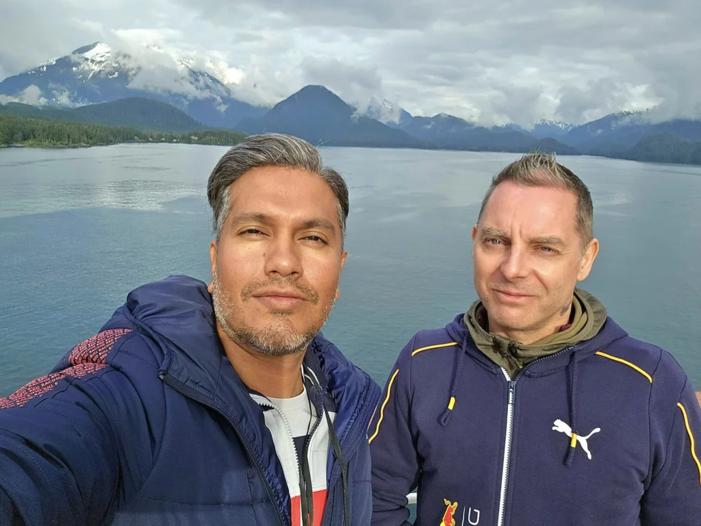 Cruising with Danny and Peter, Holland America Line, Westerdam, Sitka, Alaska, United States | Biking the scenic Sitka Cross Trail through lush Alaskan forests, capturing Sitka's natural beauty and outdoor adventure; a whale breaching in Whale Park, showcasing Sitka Alaska's wildlife; a majestic eagle soaring above, symbolizing the rich wildlife; and an intricate Tlingit totem pole representing the cultural heritage of Sitka, Alaska, all set against the stunning coastal landscape of this Alaskan gem.