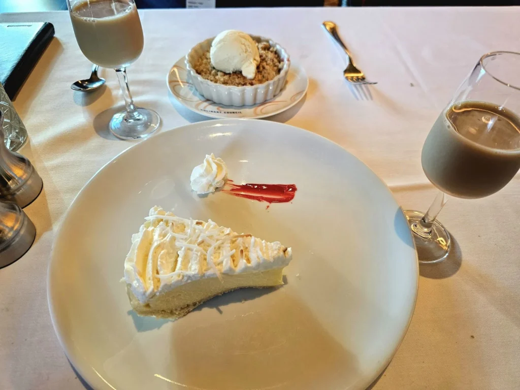 Cruising with Danny and Peter, Holland America Line, Westerdam, Hubbard Glacier, Alaska, United States | View of Hubbard Glacier from the boat during an unforgettable tour, showcasing stunning blue ice and calm Arctic waters. Thrilling ice calving event captures large chunks of ice breaking off and crashing into the water. Mirror-like reflection of the glacier on still waters highlights its majestic blue hues. A delightful picnic with the glacier in the background combines delicious food with breathtaking views, while a close-up of the glacier's intricate ice formations shows deep crevasses and jagged edges.