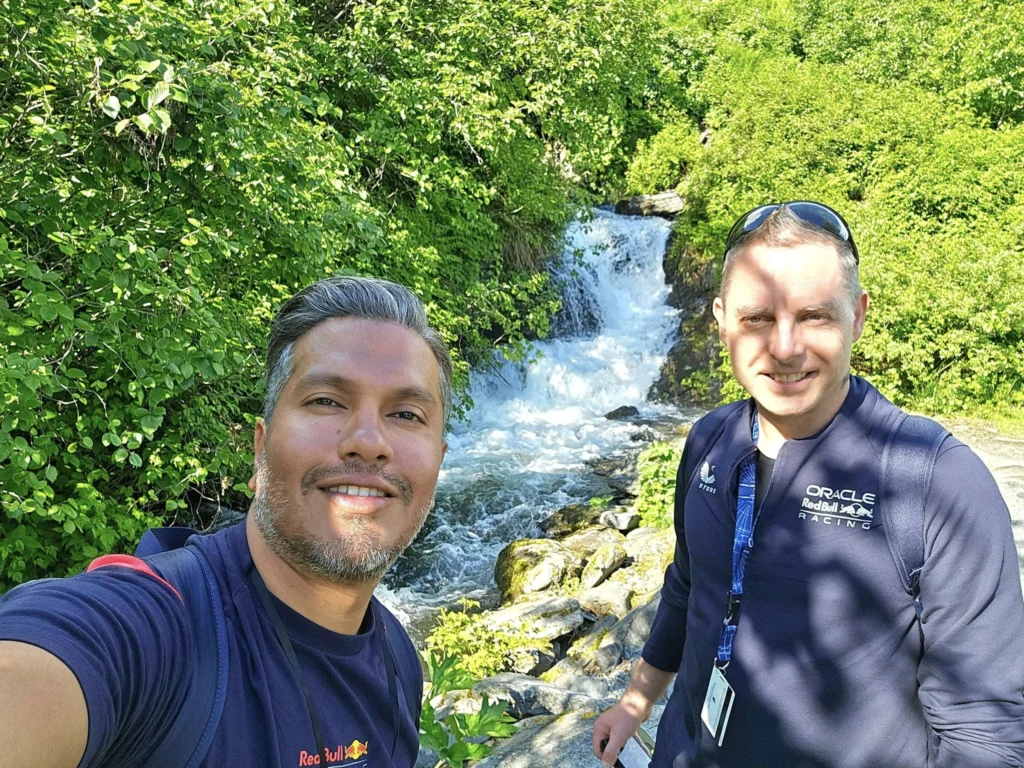 Cruising with Danny and Peter, Holland America Line, Westerdam, Prince William Sound, Valdez, Alaska, United States | A serene panorama of Prince William Sound at dawn, with the luxurious Westerdam cruise ship gliding through calm waters, surrounded by snow-capped mountains and glowing glaciers under a soft pink sky. Humpback whales breach the surface, their tails splashing against the reflective water, while sea otters float playfully in kelp beds and a bald eagle soars overhead. In Valdez Glacier Lake, vibrant blue icebergs drift peacefully, with kayakers in colorful kayaks paddling through the icy maze, dwarfed by the towering Valdez Glacier’s rugged ice face in the background. The Westerdam’s elegant deck features passengers enjoying a gourmet breakfast with panoramic views of the Alaskan wilderness, capturing the harmonious blend of luxury and nature.