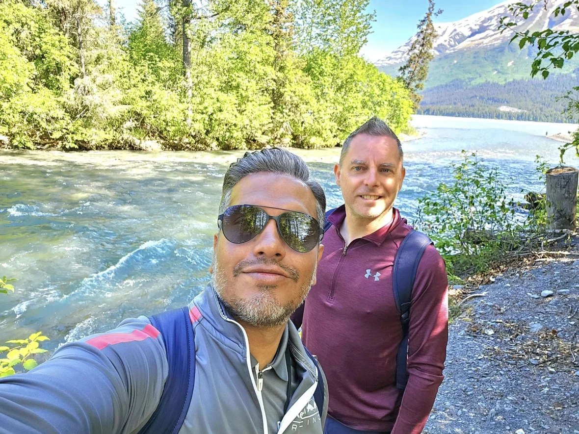 Cruising with Danny and Peter, Holland America Line, Westerdam, Seward, Alaska, United States | A panoramic view of Seward Harbor with rugged cliffs and serene waters, capturing Alaska's wilderness on a photography adventure. Travelers document vibrant wildflowers and snow-capped peaks in Chugach National Forest during an Alaska wilderness cruise. Historical remnants of the 1890 Gold Rush in Seward, including old mining equipment in lush alpine meadows, offer perfect scenes for photography enthusiasts. A majestic bald eagle soars over the tranquil waters of Seward Harbor, while senior-friendly guided tours explore accessible trails amidst stunning natural landscapes.