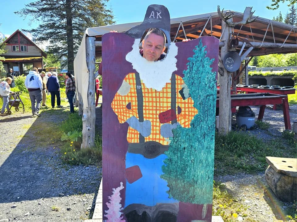 Cruising with Danny and Peter, Holland America Line, Westerdam, Seward, Alaska, United States | A panoramic view of Seward Harbor with rugged cliffs and serene waters, capturing Alaska's wilderness on a photography adventure. Travelers document vibrant wildflowers and snow-capped peaks in Chugach National Forest during an Alaska wilderness cruise. Historical remnants of the 1890 Gold Rush in Seward, including old mining equipment in lush alpine meadows, offer perfect scenes for photography enthusiasts. A majestic bald eagle soars over the tranquil waters of Seward Harbor, while senior-friendly guided tours explore accessible trails amidst stunning natural landscapes.