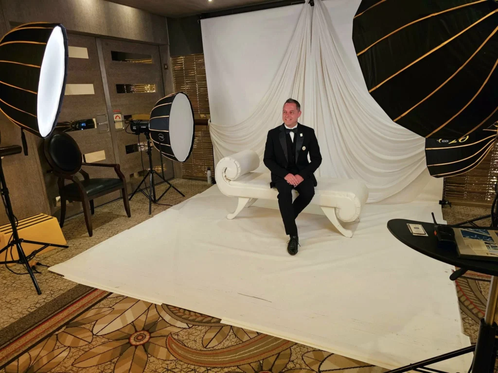 Cruising with Danny and Peter, Holland America Line, Westerdam, Seward, Alaska, United States | A panoramic view of Seward Harbor with rugged cliffs and serene waters, capturing Alaska's wilderness on a photography adventure. Travelers document vibrant wildflowers and snow-capped peaks in Chugach National Forest during an Alaska wilderness cruise. Historical remnants of the 1890 Gold Rush in Seward, including old mining equipment in lush alpine meadows, offer perfect scenes for photography enthusiasts. A majestic bald eagle soars over the tranquil waters of Seward Harbor, while senior-friendly guided tours explore accessible trails amidst stunning natural landscapes.