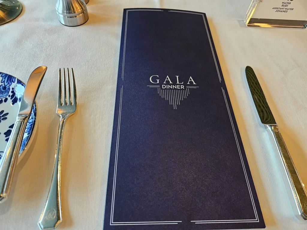 Cruising with Danny and Peter, Holland America Line, Westerdam, Seward, Alaska, United States | A panoramic view of Seward Harbor with rugged cliffs and serene waters, capturing Alaska's wilderness on a photography adventure. Travelers document vibrant wildflowers and snow-capped peaks in Chugach National Forest during an Alaska wilderness cruise. Historical remnants of the 1890 Gold Rush in Seward, including old mining equipment in lush alpine meadows, offer perfect scenes for photography enthusiasts. A majestic bald eagle soars over the tranquil waters of Seward Harbor, while senior-friendly guided tours explore accessible trails amidst stunning natural landscapes.