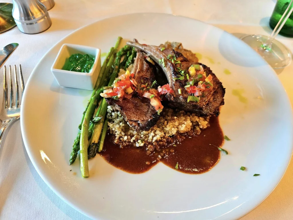 Cruising with Danny and Peter, Holland America Line, Westerdam, Seward, Alaska, United States | A panoramic view of Seward Harbor with rugged cliffs and serene waters, capturing Alaska's wilderness on a photography adventure. Travelers document vibrant wildflowers and snow-capped peaks in Chugach National Forest during an Alaska wilderness cruise. Historical remnants of the 1890 Gold Rush in Seward, including old mining equipment in lush alpine meadows, offer perfect scenes for photography enthusiasts. A majestic bald eagle soars over the tranquil waters of Seward Harbor, while senior-friendly guided tours explore accessible trails amidst stunning natural landscapes.