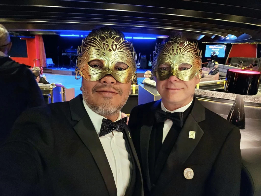 Cruising with Danny and Peter, Holland America Line, Westerdam, Seward, Alaska, United States | A panoramic view of Seward Harbor with rugged cliffs and serene waters, capturing Alaska's wilderness on a photography adventure. Travelers document vibrant wildflowers and snow-capped peaks in Chugach National Forest during an Alaska wilderness cruise. Historical remnants of the 1890 Gold Rush in Seward, including old mining equipment in lush alpine meadows, offer perfect scenes for photography enthusiasts. A majestic bald eagle soars over the tranquil waters of Seward Harbor, while senior-friendly guided tours explore accessible trails amidst stunning natural landscapes.