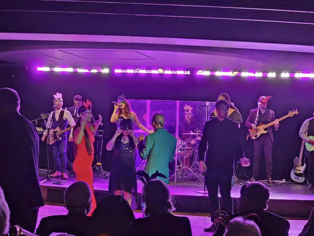 Cruising with Danny and Peter, Holland America Line, Westerdam, Seward, Alaska, United States | A panoramic view of Seward Harbor with rugged cliffs and serene waters, capturing Alaska's wilderness on a photography adventure. Travelers document vibrant wildflowers and snow-capped peaks in Chugach National Forest during an Alaska wilderness cruise. Historical remnants of the 1890 Gold Rush in Seward, including old mining equipment in lush alpine meadows, offer perfect scenes for photography enthusiasts. A majestic bald eagle soars over the tranquil waters of Seward Harbor, while senior-friendly guided tours explore accessible trails amidst stunning natural landscapes.