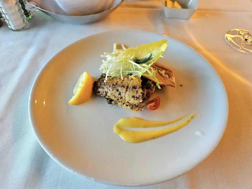 Cruising with Danny and Peter, Holland America Line, Westerdam, Gulf of Alaska, Alaska, United States | Elegant dining room with panoramic ocean views during an Alaska sea day brunch, featuring a spread of gourmet dishes and Alaskan specialties.