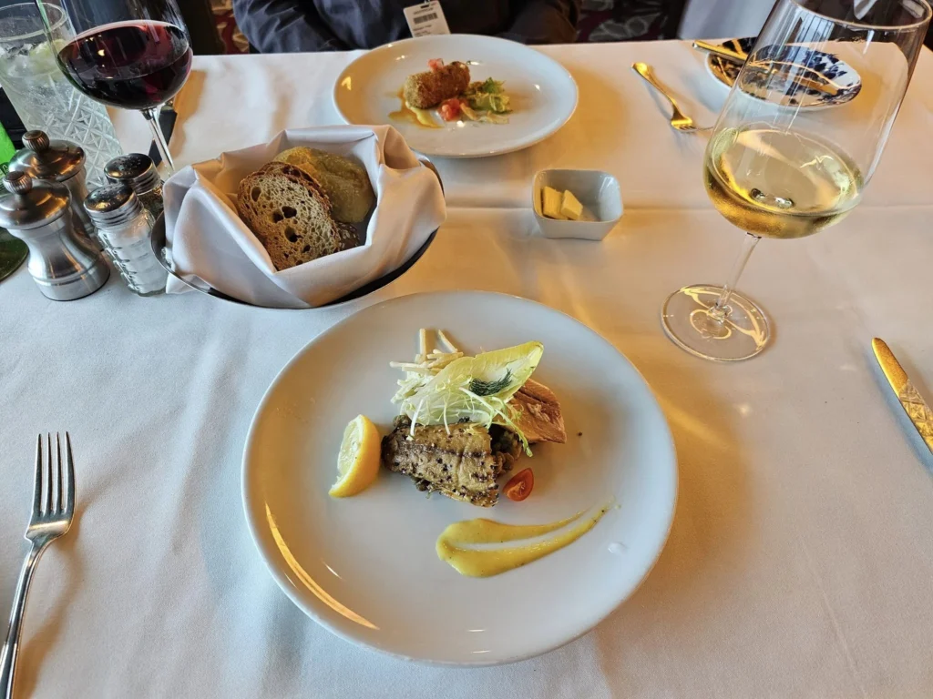 Cruising with Danny and Peter, Holland America Line, Westerdam, Gulf of Alaska, Alaska, United States | Elegant dining room with panoramic ocean views during an Alaska sea day brunch, featuring a spread of gourmet dishes and Alaskan specialties.