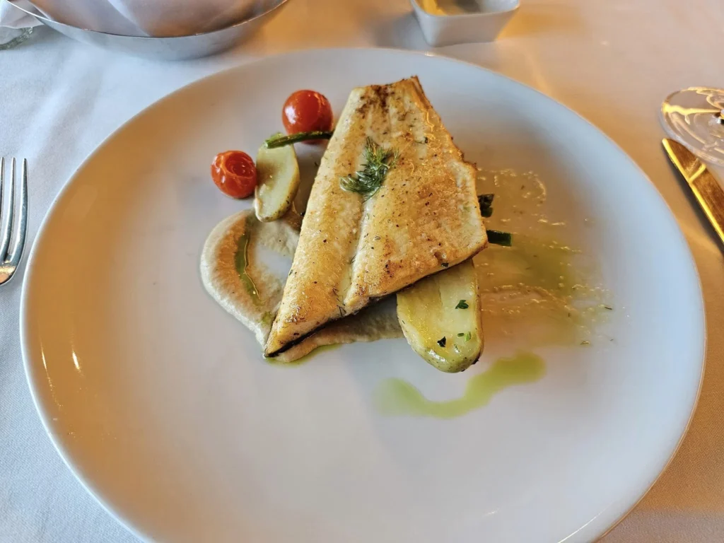 Cruising with Danny and Peter, Holland America Line, Westerdam, Gulf of Alaska, Alaska, United States | Elegant dining room with panoramic ocean views during an Alaska sea day brunch, featuring a spread of gourmet dishes and Alaskan specialties.