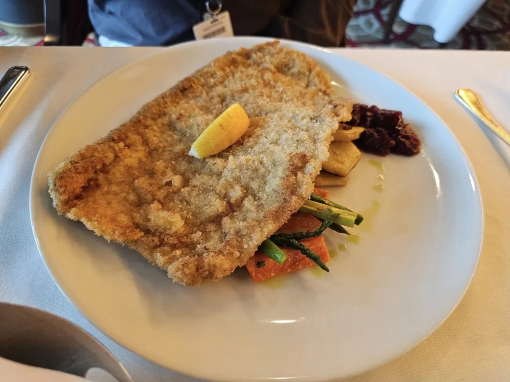 Cruising with Danny and Peter, Holland America Line, Westerdam, Gulf of Alaska, Alaska, United States | Elegant dining room with panoramic ocean views during an Alaska sea day brunch, featuring a spread of gourmet dishes and Alaskan specialties.