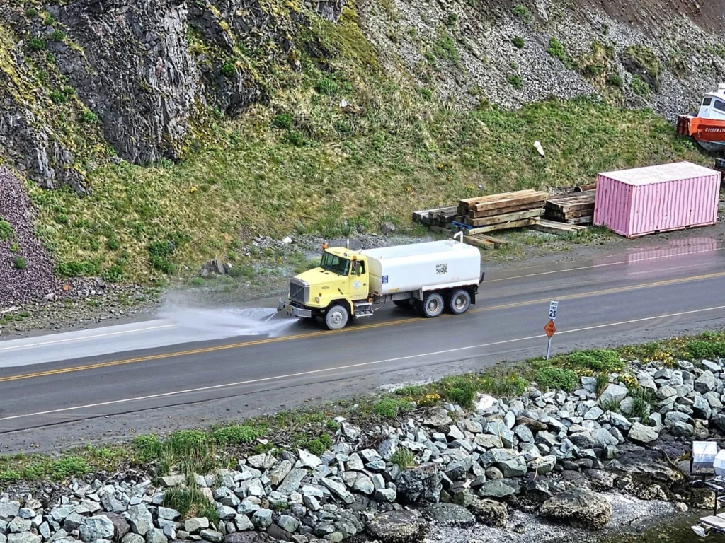 Cruising with Danny and Peter, Holland America Line, Westerdam, Dutch Harbor, Unlaska, Alaska, United States | Scenic view of Dutch Harbor Unalaska featuring rugged mountains and the Bering Sea, with a hiker on Mount Ballyhoo Trail, a majestic bald eagle soaring above, and the historic Russian Orthodox Church with its distinctive onion domes. Includes a fresh seafood dish representing local cuisine and a birdwatching spot at Unalaska Island Bird Sanctuary, capturing the charm of Unalaska's blend of natural beauty, wildlife, and cultural heritage.