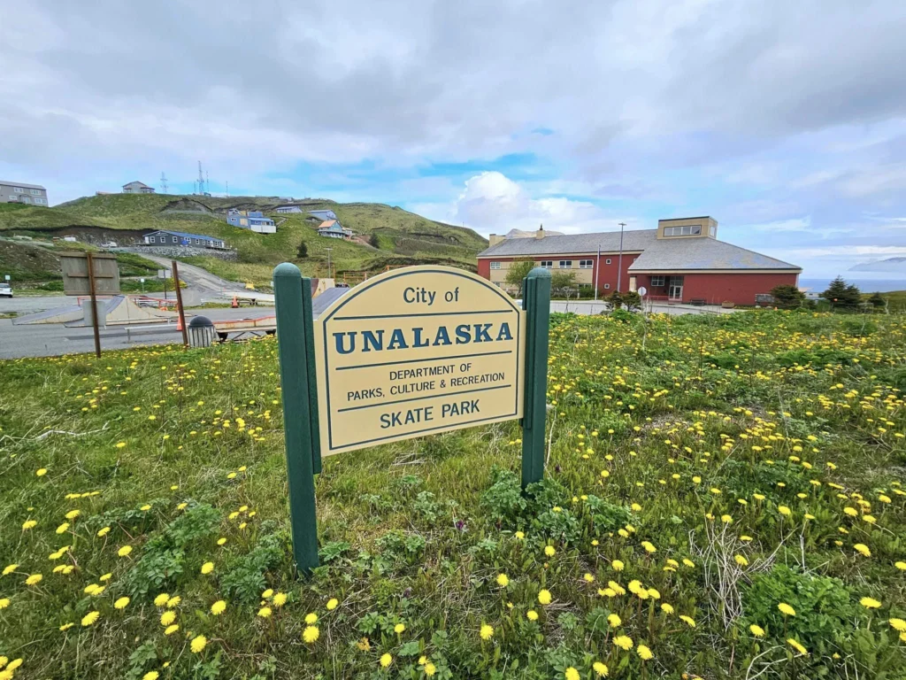 Cruising with Danny and Peter, Holland America Line, Westerdam, Dutch Harbor, Unlaska, Alaska, United States | Scenic view of Dutch Harbor Unalaska featuring rugged mountains and the Bering Sea, with a hiker on Mount Ballyhoo Trail, a majestic bald eagle soaring above, and the historic Russian Orthodox Church with its distinctive onion domes. Includes a fresh seafood dish representing local cuisine and a birdwatching spot at Unalaska Island Bird Sanctuary, capturing the charm of Unalaska's blend of natural beauty, wildlife, and cultural heritage.