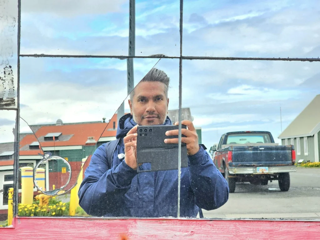 Cruising with Danny and Peter, Holland America Line, Westerdam, Dutch Harbor, Unlaska, Alaska, United States | Scenic view of Dutch Harbor Unalaska featuring rugged mountains and the Bering Sea, with a hiker on Mount Ballyhoo Trail, a majestic bald eagle soaring above, and the historic Russian Orthodox Church with its distinctive onion domes. Includes a fresh seafood dish representing local cuisine and a birdwatching spot at Unalaska Island Bird Sanctuary, capturing the charm of Unalaska's blend of natural beauty, wildlife, and cultural heritage.