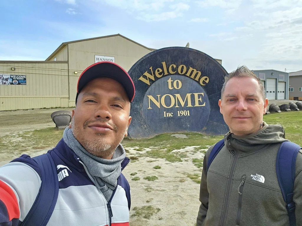 Discovering Newton Peak Hike in Nome, Alaska: A Comprehensive Adventure Guide 10 Cruising with Danny and Peter, Holland America Line, Westerdam, Nome, Alaska, United States | Scenic images of the Newton Peak Hike in Nome, Alaska, including the trailhead marking the start of the adventure, hikers ascending the challenging terrain, panoramic summit views of rolling hills and the Bering Sea, wildlife like curious squirrels and soaring birds along the trail, and vibrant wildflowers adding color to the rugged landscape.