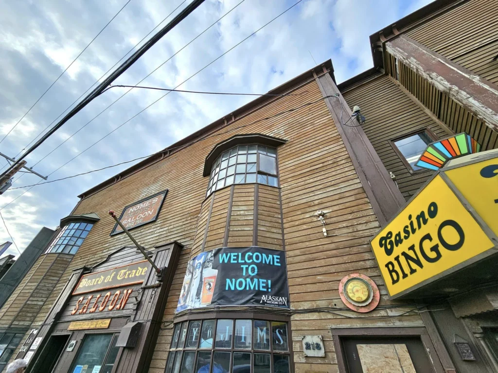 Discovering Newton Peak Hike in Nome, Alaska: A Comprehensive Adventure Guide 21 Cruising with Danny and Peter, Holland America Line, Westerdam, Nome, Alaska, United States | Scenic images of the Newton Peak Hike in Nome, Alaska, including the trailhead marking the start of the adventure, hikers ascending the challenging terrain, panoramic summit views of rolling hills and the Bering Sea, wildlife like curious squirrels and soaring birds along the trail, and vibrant wildflowers adding color to the rugged landscape.