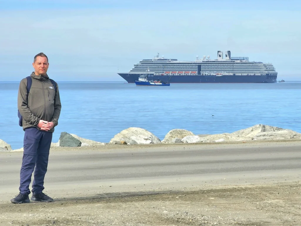 Discovering Newton Peak Hike in Nome, Alaska: A Comprehensive Adventure Guide 32 Cruising with Danny and Peter, Holland America Line, Westerdam, Nome, Alaska, United States | Scenic images of the Newton Peak Hike in Nome, Alaska, including the trailhead marking the start of the adventure, hikers ascending the challenging terrain, panoramic summit views of rolling hills and the Bering Sea, wildlife like curious squirrels and soaring birds along the trail, and vibrant wildflowers adding color to the rugged landscape.