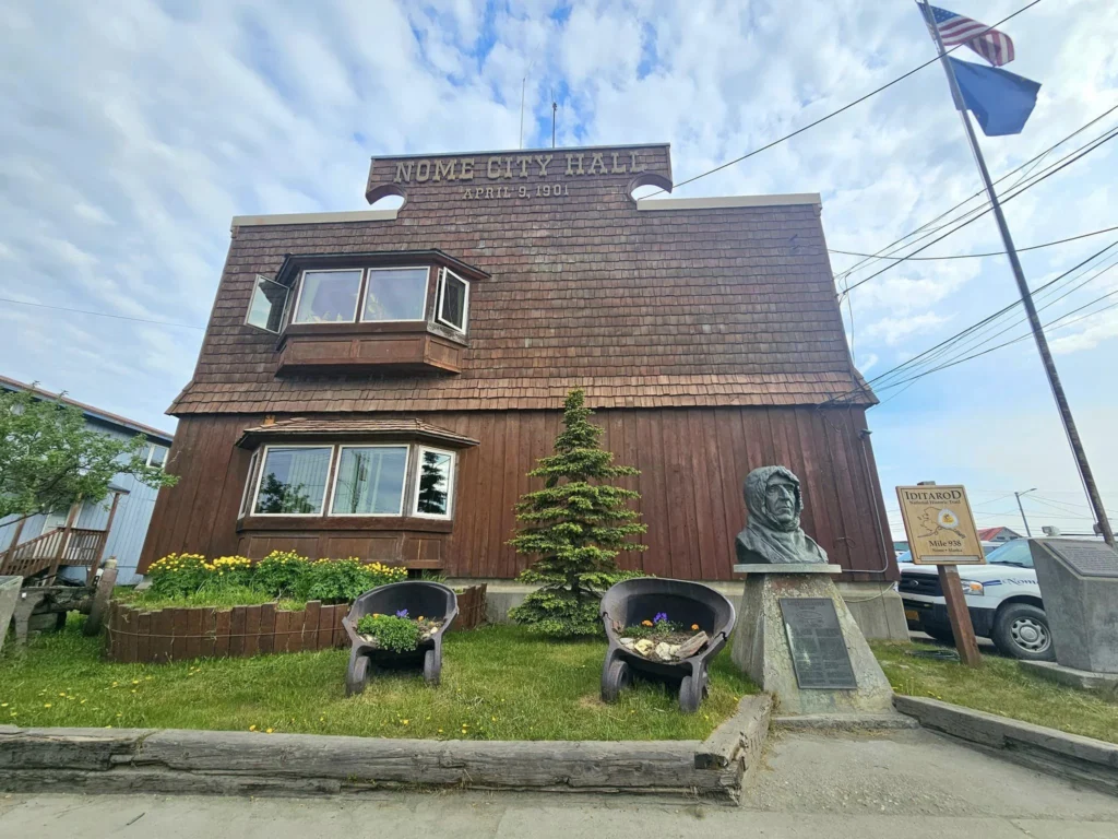 Discovering Newton Peak Hike in Nome, Alaska: A Comprehensive Adventure Guide 35 Cruising with Danny and Peter, Holland America Line, Westerdam, Nome, Alaska, United States | Scenic images of the Newton Peak Hike in Nome, Alaska, including the trailhead marking the start of the adventure, hikers ascending the challenging terrain, panoramic summit views of rolling hills and the Bering Sea, wildlife like curious squirrels and soaring birds along the trail, and vibrant wildflowers adding color to the rugged landscape.