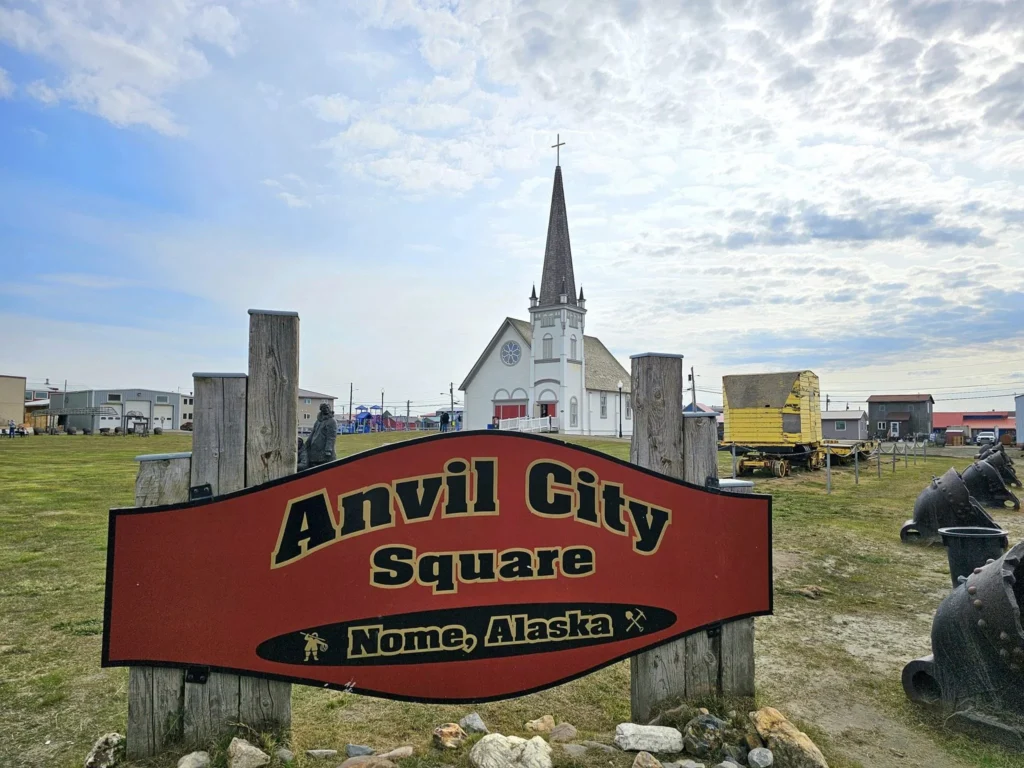 Discovering Newton Peak Hike in Nome, Alaska: A Comprehensive Adventure Guide 36 Cruising with Danny and Peter, Holland America Line, Westerdam, Nome, Alaska, United States | Scenic images of the Newton Peak Hike in Nome, Alaska, including the trailhead marking the start of the adventure, hikers ascending the challenging terrain, panoramic summit views of rolling hills and the Bering Sea, wildlife like curious squirrels and soaring birds along the trail, and vibrant wildflowers adding color to the rugged landscape.