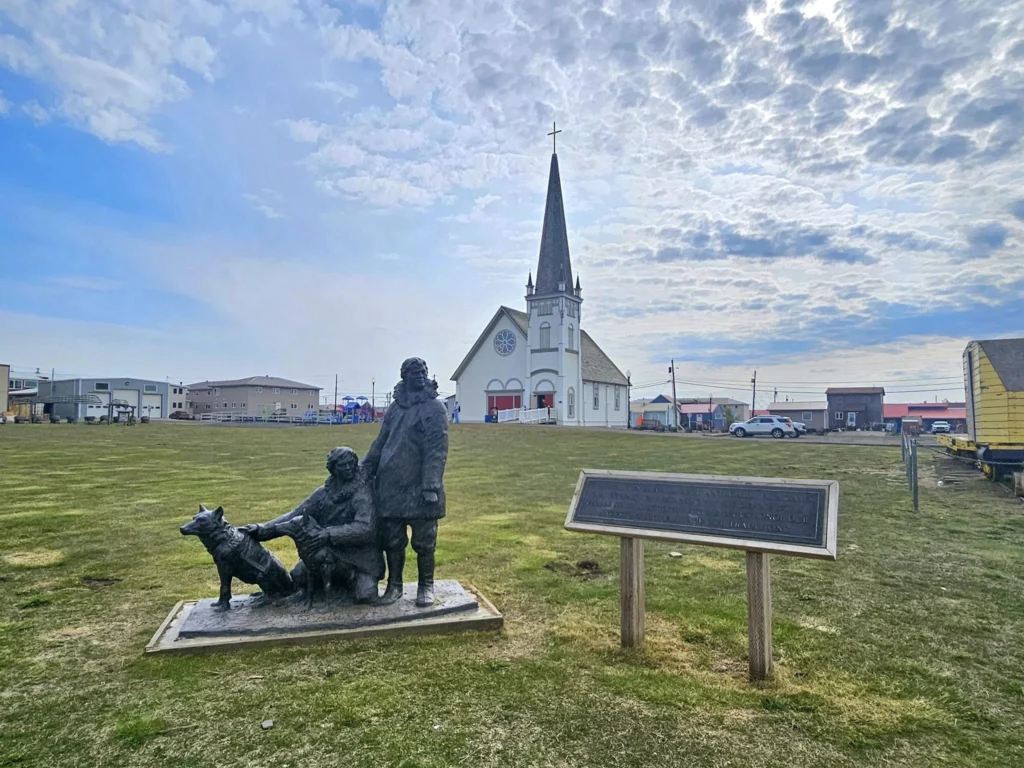 Discovering Newton Peak Hike in Nome, Alaska: A Comprehensive Adventure Guide 37 Cruising with Danny and Peter, Holland America Line, Westerdam, Nome, Alaska, United States | Scenic images of the Newton Peak Hike in Nome, Alaska, including the trailhead marking the start of the adventure, hikers ascending the challenging terrain, panoramic summit views of rolling hills and the Bering Sea, wildlife like curious squirrels and soaring birds along the trail, and vibrant wildflowers adding color to the rugged landscape.