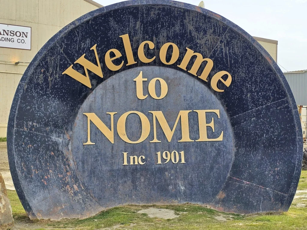 Discovering Newton Peak Hike in Nome, Alaska: A Comprehensive Adventure Guide 42 Cruising with Danny and Peter, Holland America Line, Westerdam, Nome, Alaska, United States | Scenic images of the Newton Peak Hike in Nome, Alaska, including the trailhead marking the start of the adventure, hikers ascending the challenging terrain, panoramic summit views of rolling hills and the Bering Sea, wildlife like curious squirrels and soaring birds along the trail, and vibrant wildflowers adding color to the rugged landscape.