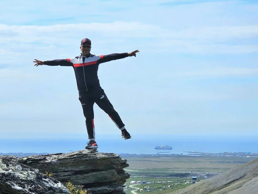 Discovering Newton Peak Hike in Nome, Alaska: A Comprehensive Adventure Guide 3 Cruising with Danny and Peter, Holland America Line, Westerdam, Nome, Alaska, United States | Scenic images of the Newton Peak Hike in Nome, Alaska, including the trailhead marking the start of the adventure, hikers ascending the challenging terrain, panoramic summit views of rolling hills and the Bering Sea, wildlife like curious squirrels and soaring birds along the trail, and vibrant wildflowers adding color to the rugged landscape.