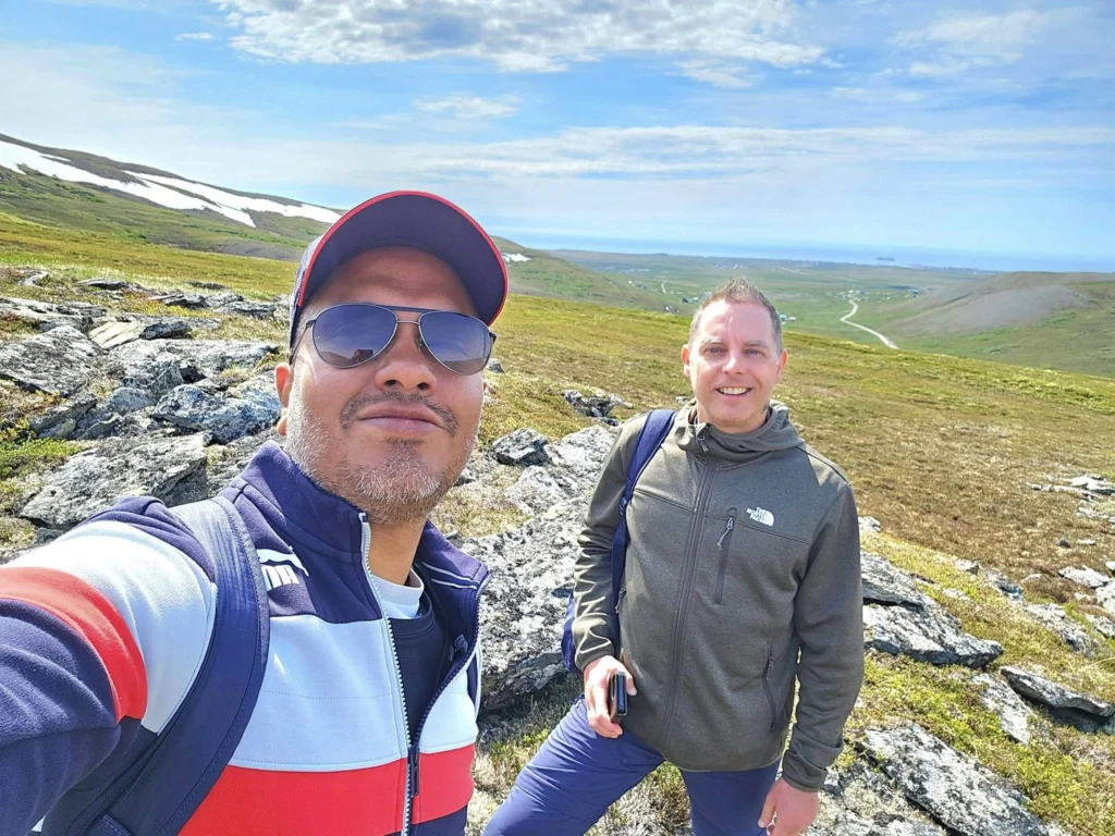 Discovering Newton Peak Hike in Nome, Alaska: A Comprehensive Adventure Guide 55 Cruising with Danny and Peter, Holland America Line, Westerdam, Nome, Alaska, United States | Scenic images of the Newton Peak Hike in Nome, Alaska, including the trailhead marking the start of the adventure, hikers ascending the challenging terrain, panoramic summit views of rolling hills and the Bering Sea, wildlife like curious squirrels and soaring birds along the trail, and vibrant wildflowers adding color to the rugged landscape.