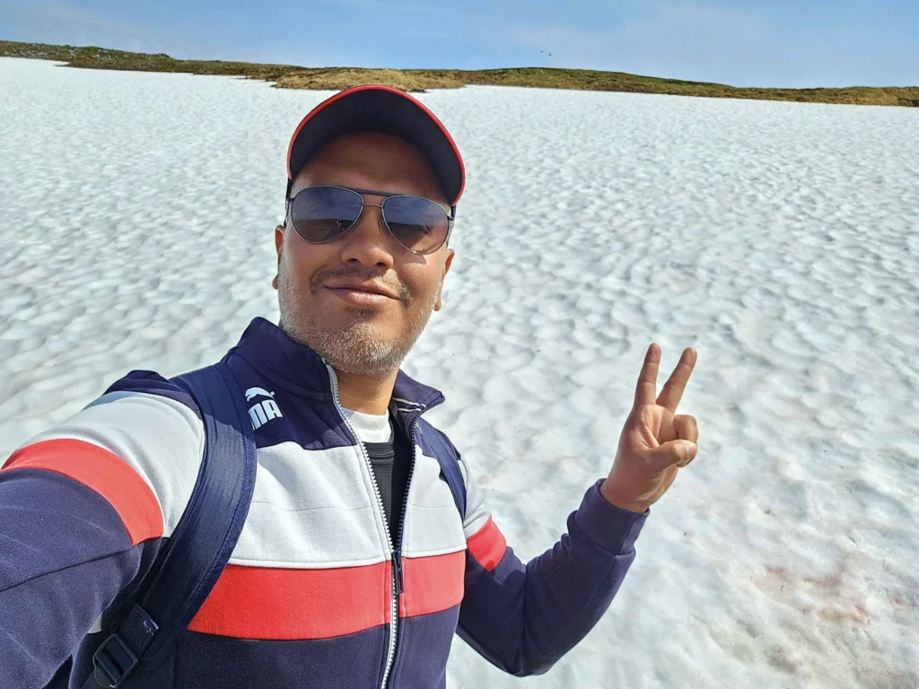 Discovering Newton Peak Hike in Nome, Alaska: A Comprehensive Adventure Guide 59 Cruising with Danny and Peter, Holland America Line, Westerdam, Nome, Alaska, United States | Scenic images of the Newton Peak Hike in Nome, Alaska, including the trailhead marking the start of the adventure, hikers ascending the challenging terrain, panoramic summit views of rolling hills and the Bering Sea, wildlife like curious squirrels and soaring birds along the trail, and vibrant wildflowers adding color to the rugged landscape.