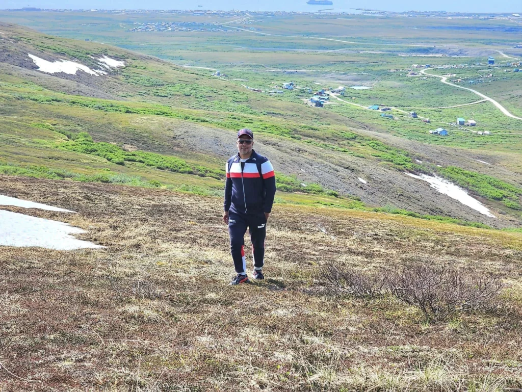 Discovering Newton Peak Hike in Nome, Alaska: A Comprehensive Adventure Guide 62 Cruising with Danny and Peter, Holland America Line, Westerdam, Nome, Alaska, United States | Scenic images of the Newton Peak Hike in Nome, Alaska, including the trailhead marking the start of the adventure, hikers ascending the challenging terrain, panoramic summit views of rolling hills and the Bering Sea, wildlife like curious squirrels and soaring birds along the trail, and vibrant wildflowers adding color to the rugged landscape.