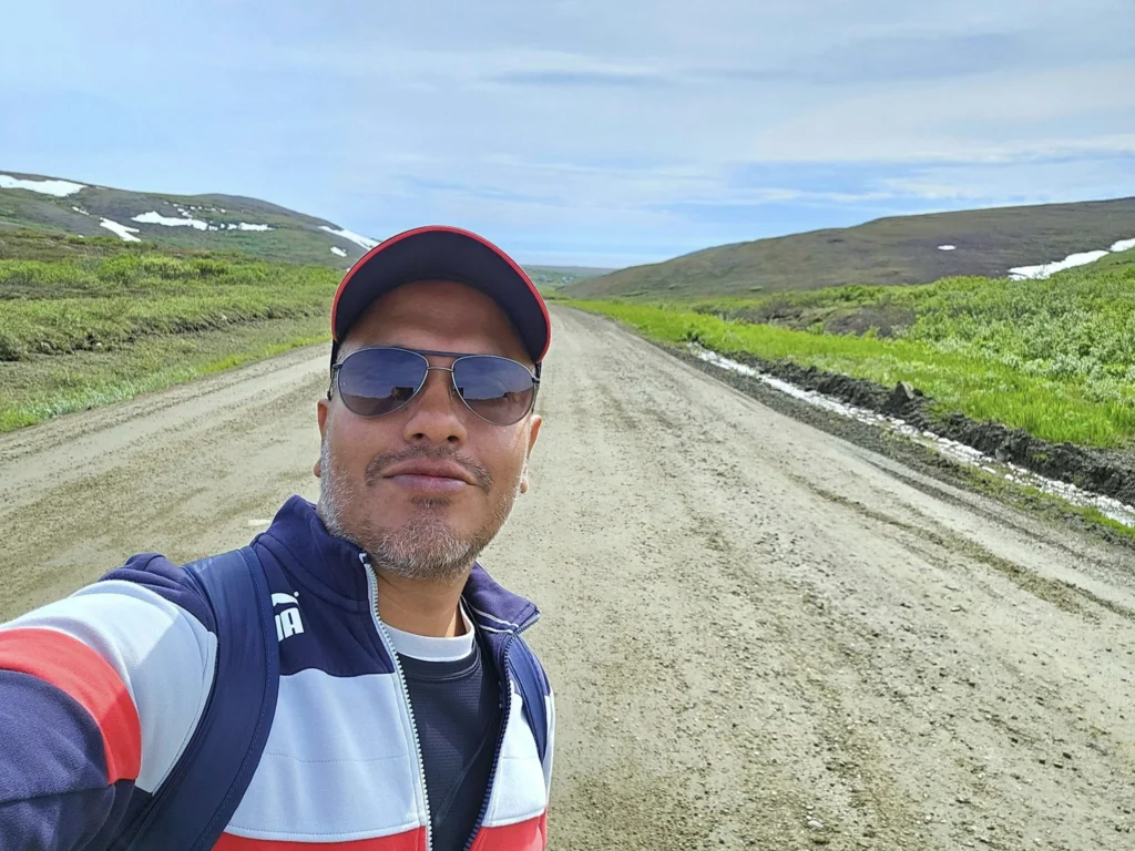 Discovering Newton Peak Hike in Nome, Alaska: A Comprehensive Adventure Guide 79 Cruising with Danny and Peter, Holland America Line, Westerdam, Nome, Alaska, United States | Scenic images of the Newton Peak Hike in Nome, Alaska, including the trailhead marking the start of the adventure, hikers ascending the challenging terrain, panoramic summit views of rolling hills and the Bering Sea, wildlife like curious squirrels and soaring birds along the trail, and vibrant wildflowers adding color to the rugged landscape.