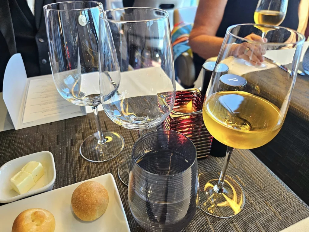 Cruising with Danny and Peter, Holland America Line, Westerdam, Unimak Passage, Alaska, United States | Elegant setting of the Canaletto restaurant on the Holland America Line Westerdam, featuring exquisite dishes such as crab and lobster salad, hand-made pumpkin pasta, seared scallops and shrimp, slow-roasted beef tenderloin, and warm chocolate torta, each paired with exceptional wines like Villa Sandi iL Presco Prosecco, Feudi di San Gregorio Greco di Tufo, Pio Cesare Piodilei Chardonnay, and Pio Cesare Barolo, showcasing the ultimate fine dining experience on the luxury cruise.