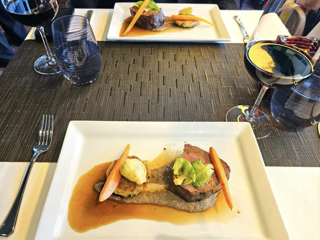 Cruising with Danny and Peter, Holland America Line, Westerdam, Unimak Passage, Alaska, United States | Elegant setting of the Canaletto restaurant on the Holland America Line Westerdam, featuring exquisite dishes such as crab and lobster salad, hand-made pumpkin pasta, seared scallops and shrimp, slow-roasted beef tenderloin, and warm chocolate torta, each paired with exceptional wines like Villa Sandi iL Presco Prosecco, Feudi di San Gregorio Greco di Tufo, Pio Cesare Piodilei Chardonnay, and Pio Cesare Barolo, showcasing the ultimate fine dining experience on the luxury cruise.