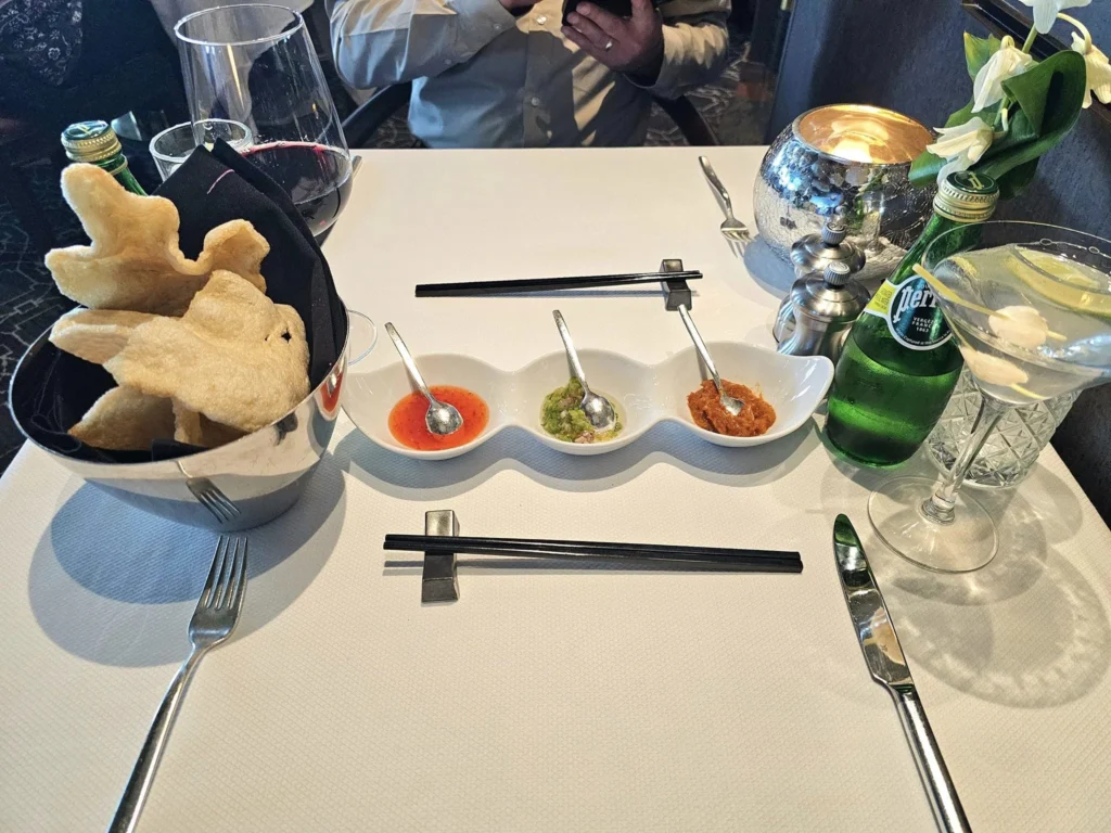 Cruising with Danny and Peter, Holland America Line, Westerdam, Kodiak, Alaska, United States | Explore Fort Abercrombie State Historical Park in Kodiak, Alaska, with views of WWII coastal defense remnants, the Observation Tower, and scenic Piedmont Point. Experience an exquisite dinner at Tamarind in the Pinnacle Grill aboard an Alaska Arctic Circle Solstice cruise, featuring Asian-inspired cuisine.