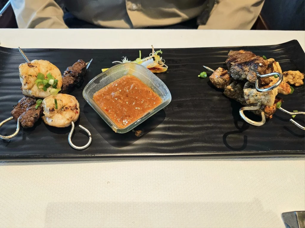 Cruising with Danny and Peter, Holland America Line, Westerdam, Kodiak, Alaska, United States | Explore Fort Abercrombie State Historical Park in Kodiak, Alaska, with views of WWII coastal defense remnants, the Observation Tower, and scenic Piedmont Point. Experience an exquisite dinner at Tamarind in the Pinnacle Grill aboard an Alaska Arctic Circle Solstice cruise, featuring Asian-inspired cuisine.