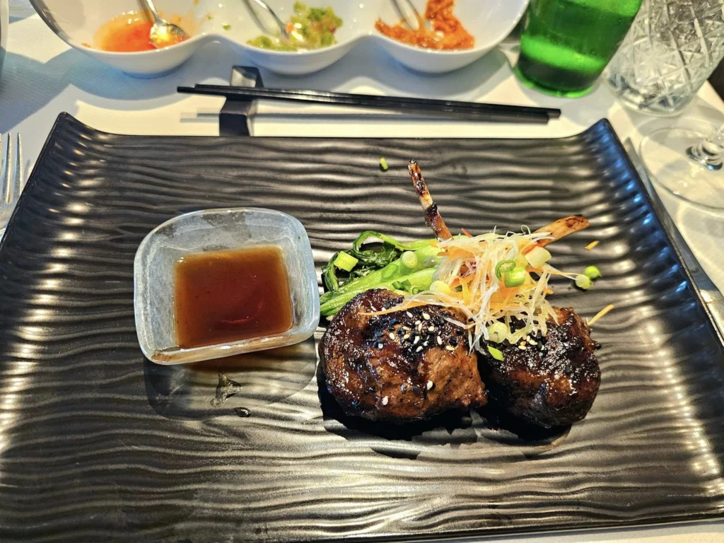 Cruising with Danny and Peter, Holland America Line, Westerdam, Kodiak, Alaska, United States | Explore Fort Abercrombie State Historical Park in Kodiak, Alaska, with views of WWII coastal defense remnants, the Observation Tower, and scenic Piedmont Point. Experience an exquisite dinner at Tamarind in the Pinnacle Grill aboard an Alaska Arctic Circle Solstice cruise, featuring Asian-inspired cuisine.