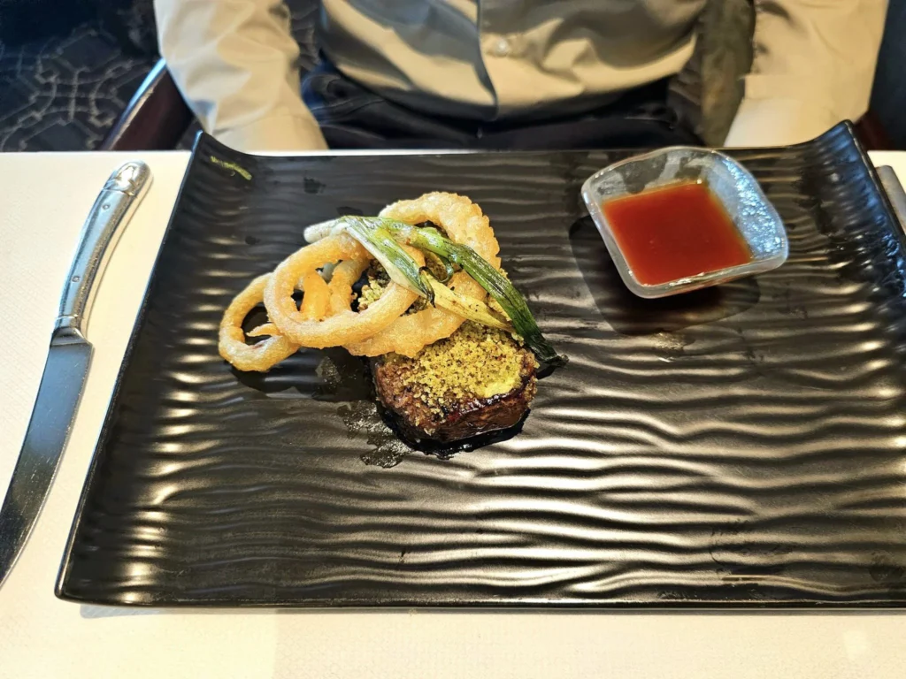 Cruising with Danny and Peter, Holland America Line, Westerdam, Kodiak, Alaska, United States | Explore Fort Abercrombie State Historical Park in Kodiak, Alaska, with views of WWII coastal defense remnants, the Observation Tower, and scenic Piedmont Point. Experience an exquisite dinner at Tamarind in the Pinnacle Grill aboard an Alaska Arctic Circle Solstice cruise, featuring Asian-inspired cuisine.