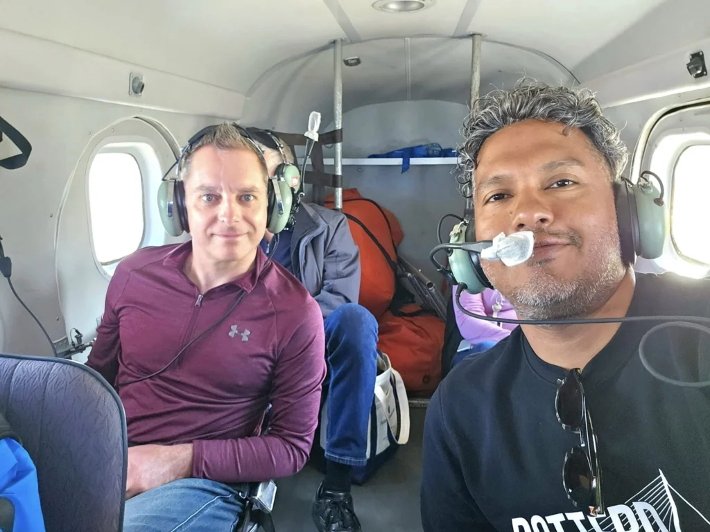 Unforgettable Alaska Flightseeing: A Journey Over Denali National Park 22 Cruising with Danny and Peter, Holland America Line, Westerdam, Anchorage, Alaska, United States | Aerial view of Denali, North America's tallest peak, and the majestic Alaska Range, captured during a Denali National Park flightseeing tour from Anchorage. The image also shows the stunning Ruth Glacier, a specialized plane with skis landing on Denali's snowy terrain, and wildlife such as moose grazing and beluga whales swimming in Cook Inlet.