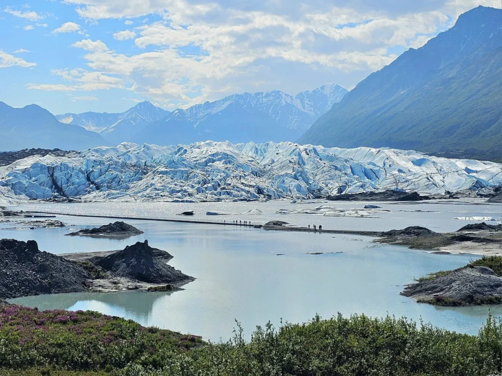 Cruising with Danny and Peter, Holland America Line, Westerdam, Anchorage, Alaska, United States | Experience the Matanuska Glacier Tour with stunning views of the glacier’s vast ice formations, an all-terrain vehicle ride, thrilling glacier hikes, and the unique refreshment of drinking crystal-clear glacial water, all complemented by stops at charming local eateries offering authentic Alaskan cuisine.