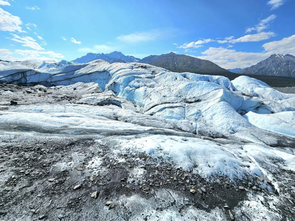 Cruising with Danny and Peter, Holland America Line, Westerdam, Anchorage, Alaska, United States | Experience the Matanuska Glacier Tour with stunning views of the glacier’s vast ice formations, an all-terrain vehicle ride, thrilling glacier hikes, and the unique refreshment of drinking crystal-clear glacial water, all complemented by stops at charming local eateries offering authentic Alaskan cuisine.