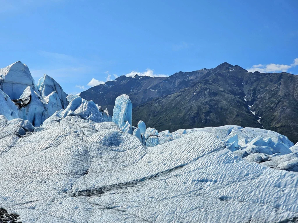 Cruising with Danny and Peter, Holland America Line, Westerdam, Anchorage, Alaska, United States | Experience the Matanuska Glacier Tour with stunning views of the glacier’s vast ice formations, an all-terrain vehicle ride, thrilling glacier hikes, and the unique refreshment of drinking crystal-clear glacial water, all complemented by stops at charming local eateries offering authentic Alaskan cuisine.