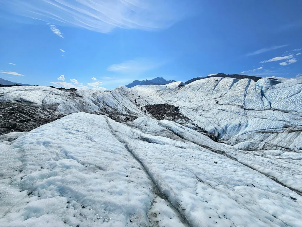 Cruising with Danny and Peter, Holland America Line, Westerdam, Anchorage, Alaska, United States | Experience the Matanuska Glacier Tour with stunning views of the glacier’s vast ice formations, an all-terrain vehicle ride, thrilling glacier hikes, and the unique refreshment of drinking crystal-clear glacial water, all complemented by stops at charming local eateries offering authentic Alaskan cuisine.