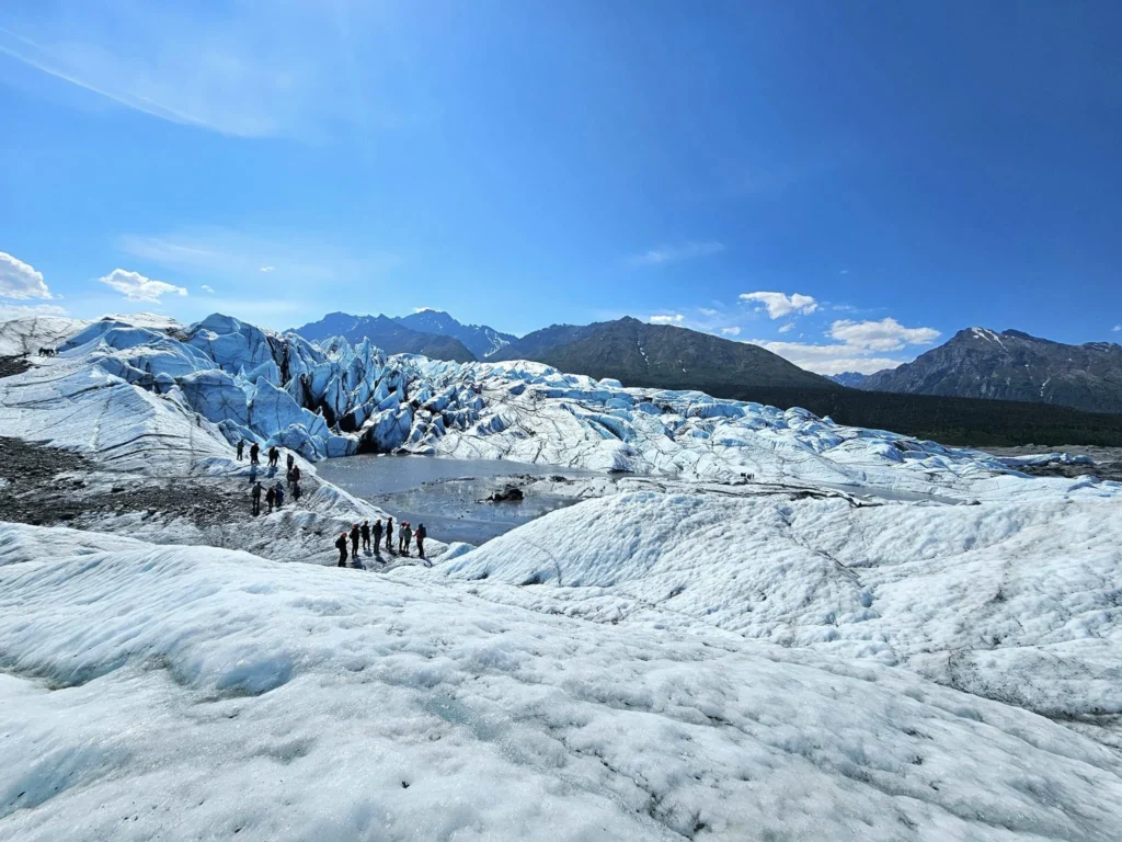 Cruising with Danny and Peter, Holland America Line, Westerdam, Anchorage, Alaska, United States | Experience the Matanuska Glacier Tour with stunning views of the glacier’s vast ice formations, an all-terrain vehicle ride, thrilling glacier hikes, and the unique refreshment of drinking crystal-clear glacial water, all complemented by stops at charming local eateries offering authentic Alaskan cuisine.