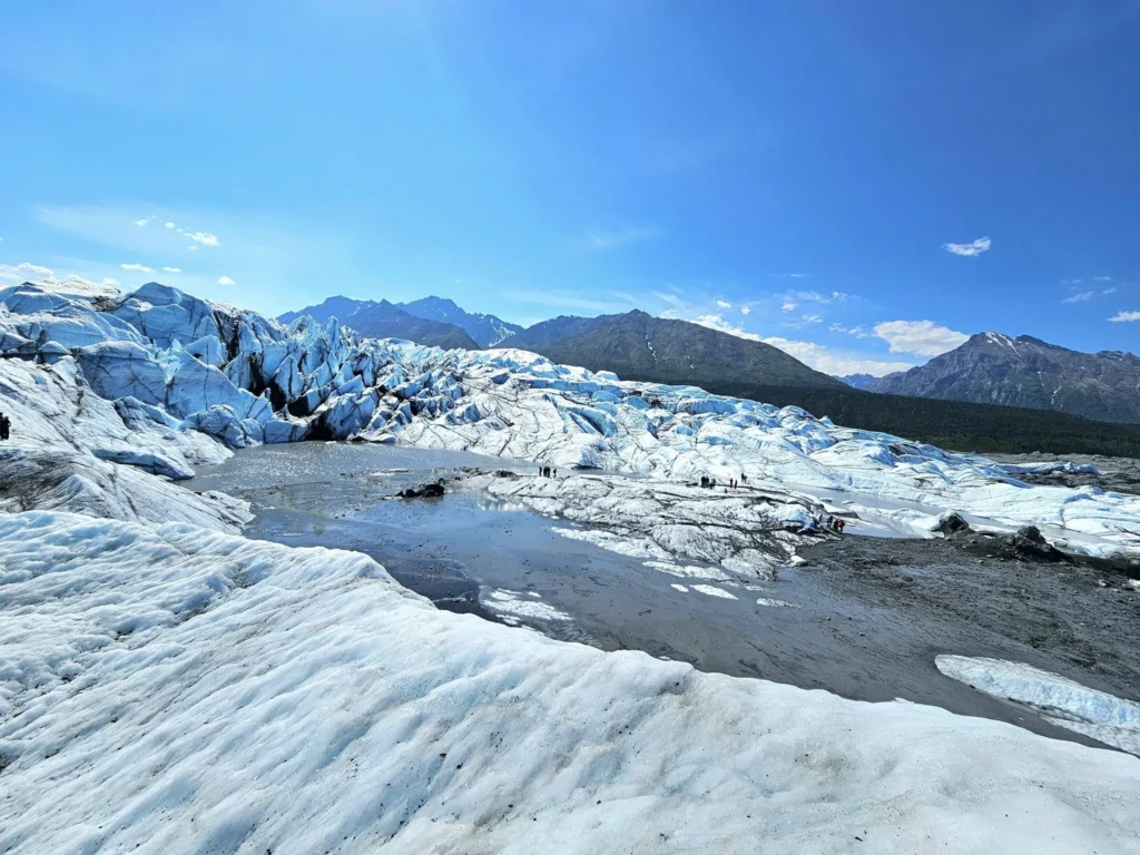 Cruising with Danny and Peter, Holland America Line, Westerdam, Anchorage, Alaska, United States | Experience the Matanuska Glacier Tour with stunning views of the glacier’s vast ice formations, an all-terrain vehicle ride, thrilling glacier hikes, and the unique refreshment of drinking crystal-clear glacial water, all complemented by stops at charming local eateries offering authentic Alaskan cuisine.